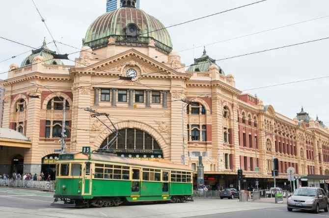 melbourne tram infront of a building 